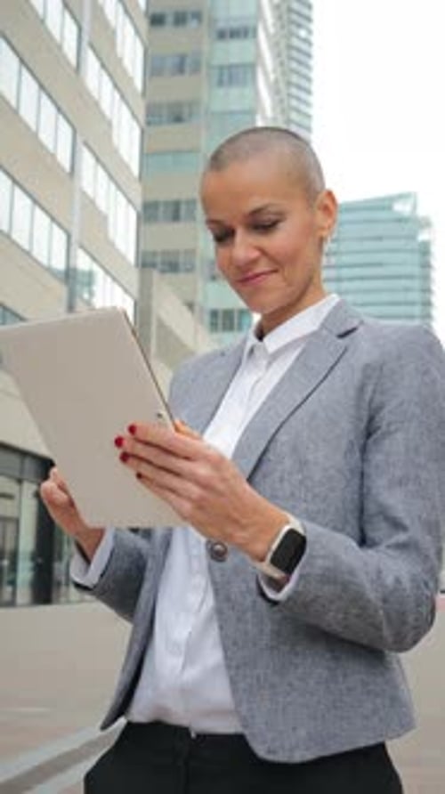 Focused Woman Using Tablet in the City