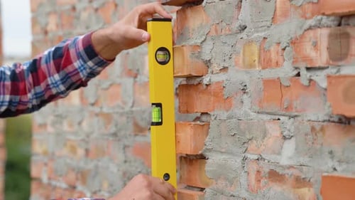 Worker Control Brick Wall Using Level Tool Close Up