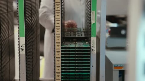 Technician Carefully Handles Circuit Boards in Slow Motion