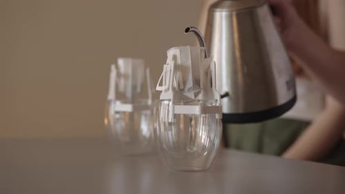 Woman Prepares Pour-Over Coffee at Home in Clear Mugs