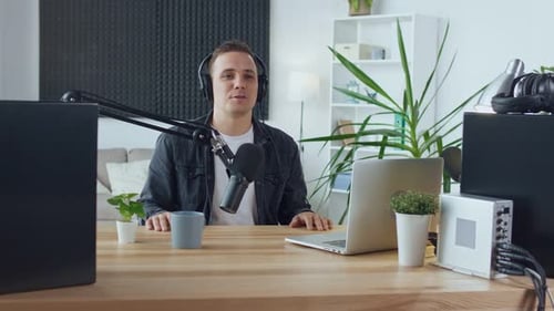 Man Recording Podcast With Microphone and Headphones