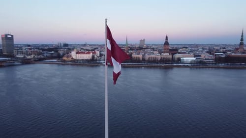 Latvia Flag Waving in Riga at Sunrise
