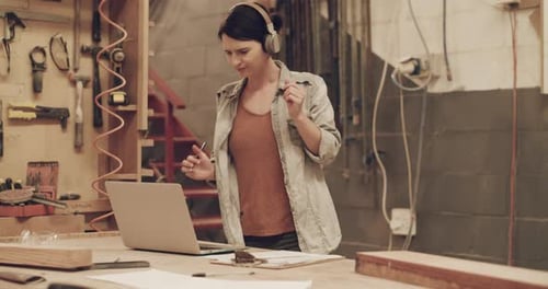 4k video footage of an attractive young female carpenter working in her woodworking workshop