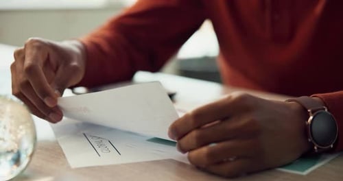 Person Reviews Invoices and Documents at Desk