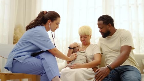 Nurse Checks Baby with Stethoscope in Home Visit