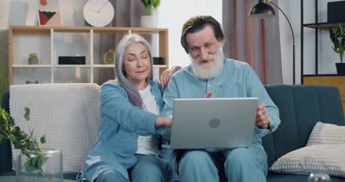 Senior Couple Video Call at Home with Laptop