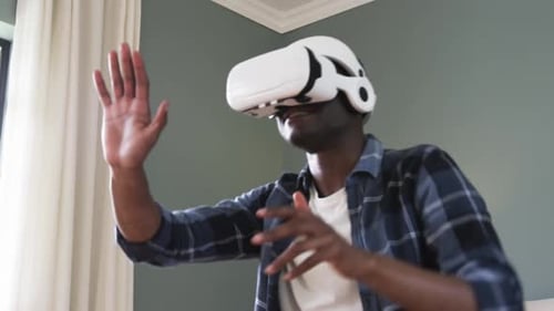 Young Man Experiencing Virtual Reality at Home