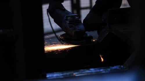 The man works circular saw, Flies of spark from hot metal, The man's hard work, Man Chlef and smooth
