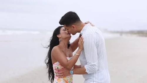 Romantic Young Couple Passionately Kissing on the Beach