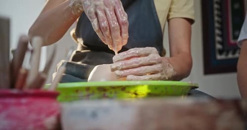 Female Potter Molding Clay Pot in Workshop