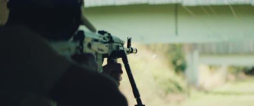 Rifle Aimed at an Outdoor Target Range