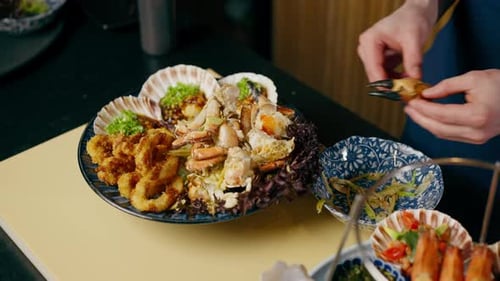 Close Up in a Japanese Restaurant Chef in Blue Prepares an Expensive Plate of Seafood