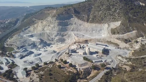Aerial view over a big quarry in a mountain.