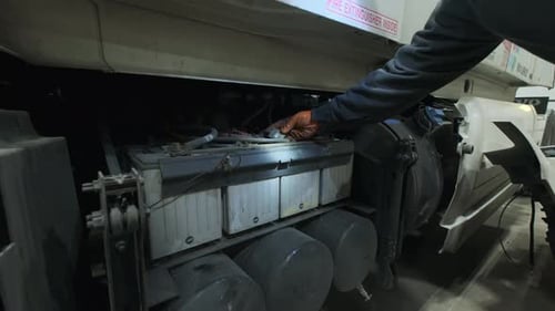 Mechanic Repairing Batteries on Commercial Truck