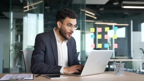 Excited Business Man Working on Laptop in Office