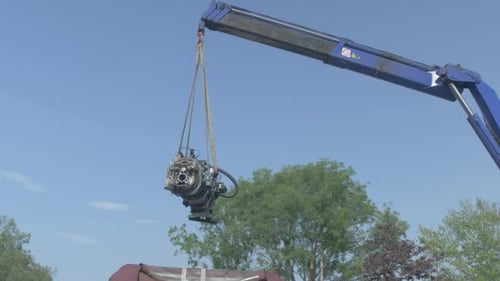 Telescopic crane lifts heavy engine