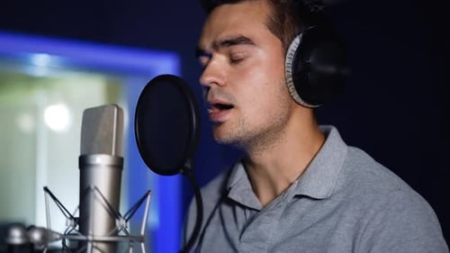 Singer recording a song in the studio.