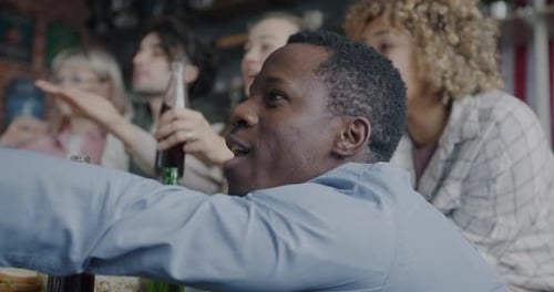 Friends Cheering During a Sports Game in Apartment