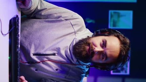 Man Gaming Online with Headphones and Computer