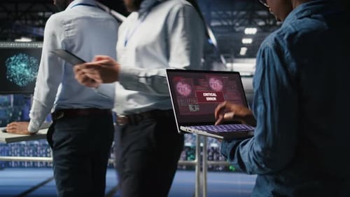 Technician in Data Center Stressed By Critical Error Popup on Laptop