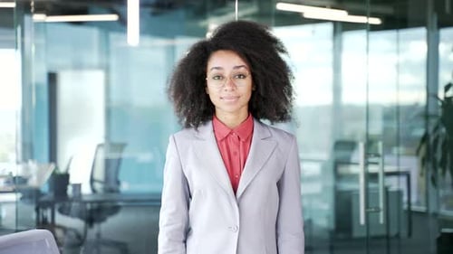 Portrait of a young confident african american businesswoman in a suit standing in a business office