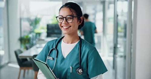 Smiling Medical Professional with Tablet in Hospital Setting