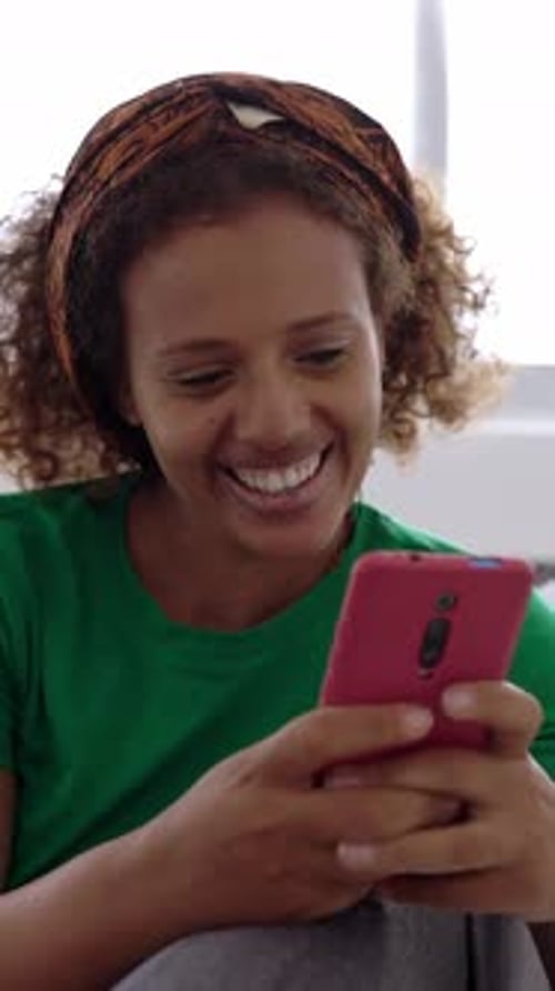 Woman Smiling While Using Smartphone Close Up