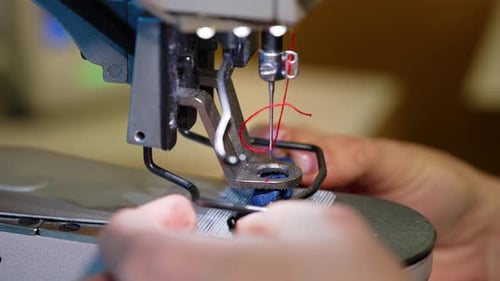 Sewing modern machine close up. Textile needle sewing equipment.