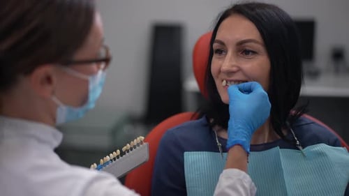 Woman Getting Tooth Shade Matching at Dentist Office