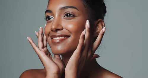 Face, skincare and beauty of happy Indian woman in studio isolated on gray background