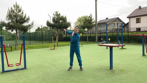 A male athlete warms up at the outdoor gym