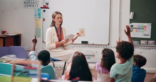 Teacher Holding Flashcards in Elementary School Classroom