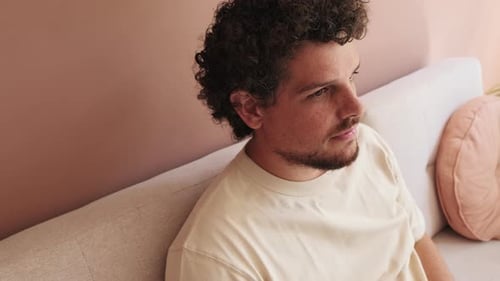 Close up, guy relaxing sitting on the sofa in cozy living room