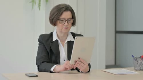 Professional Woman Using Tablet for Video Call