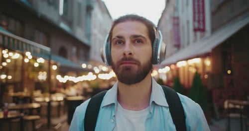 Man with Headphones Walking in City
