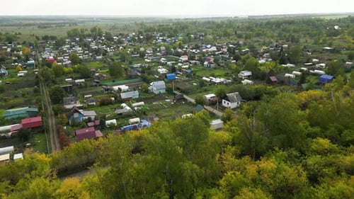 Aerial View of Beautiful Little Village or Township in Forest The Drone Flies Over the Roofs of the
