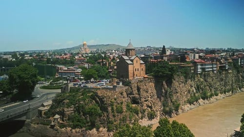 Historic Metekhi Church Overlooking Kura River in Tbilisi Drone Shot