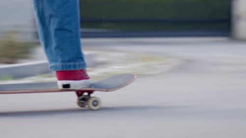 Person Riding Skateboard on Street in Residential Neighborhood