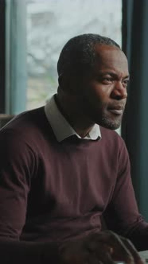 Man Using Laptop in Home Office Environment