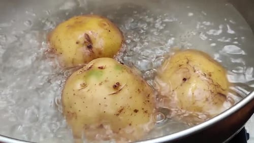 Potatoes Boiling in Bubbling Water in Silver Pot