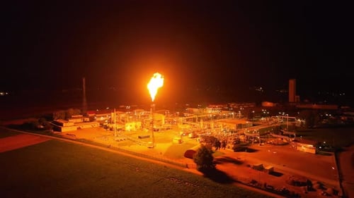 Gas Flaring Illuminates the Surrounding Area With its Radiant Light - Orbit Drone Shot