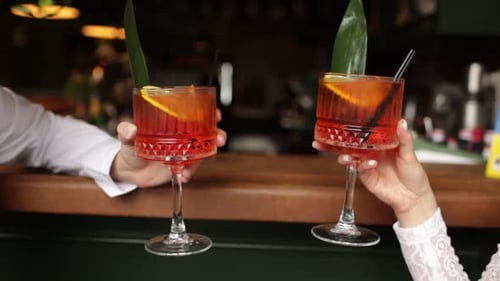 Close Up of People Holding Red Cocktails