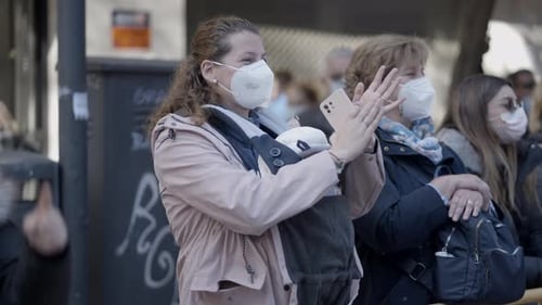 People Clapping Wearing Face Masks in Urban Environment