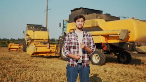 Portrait of Proud Harvester Machine Driver with Hands Crossing on Chest Farmer Standing at His
