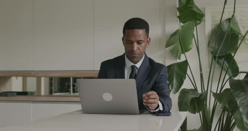 African American Business executive using Laptop at Office Desk