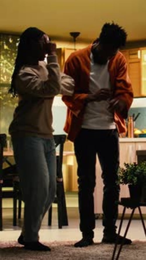 Happy Young Adults Dancing in a Home Interior