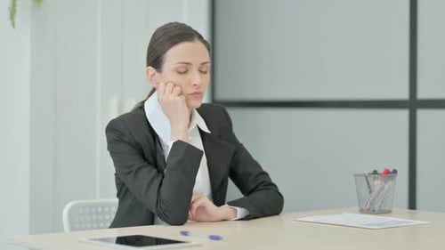 Businesswoman Sleeping while Sitting at Work