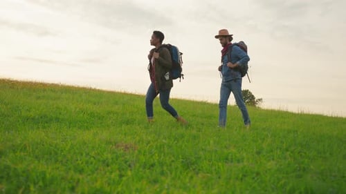 Adventurous Couple Hiking in a Grassy Mountain Meadow