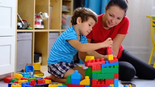 Mother and Child Play with Colorful Building Blocks
