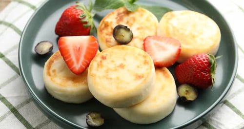 Delicious Syrniki with Fresh Strawberries and Blueberries
